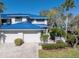 Two-story home with blue metal roof and driveway at 1621 Watermark Ne Cir # 1621, St Petersburg, FL 33702