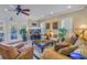 Spacious living room with comfortable seating, a large TV, and access to a balcony at 1621 Watermark Ne Cir # 1621, St Petersburg, FL 33702