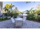 Private patio with table and chairs, surrounded by lush landscaping at 1621 Watermark Ne Cir # 1621, St Petersburg, FL 33702