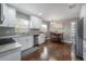 Modern kitchen featuring white cabinets, granite countertops, and stainless steel appliances at 1806 E Shadowlawn Ave, Tampa, FL 33610