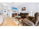 Relaxing living room featuring hardwood floors and comfortable furniture at 18255 Waydale Loop, Hudson, FL 34667