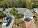 Aerial view showcasing the home's curb appeal and surrounding landscape at 1936 Grand Cypress Ln, Sun City Center, FL 33573