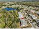 Aerial view showing home's location in a residential community near a lake at 1936 Grand Cypress Ln, Sun City Center, FL 33573