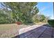 Spacious backyard with patio, lush landscaping, and mature trees at 1936 Grand Cypress Ln, Sun City Center, FL 33573