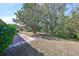 Large backyard with a patio and plenty of green space at 1936 Grand Cypress Ln, Sun City Center, FL 33573