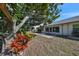 Private backyard with patio, featuring mature trees and lush landscaping at 1936 Grand Cypress Ln, Sun City Center, FL 33573