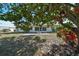 Private backyard with patio and mature landscaping at 1936 Grand Cypress Ln, Sun City Center, FL 33573