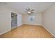 Spacious bedroom with wood-look flooring and ceiling fan at 1936 Grand Cypress Ln, Sun City Center, FL 33573