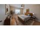 Spacious bedroom with wood flooring, large window and ceiling fan at 1936 Grand Cypress Ln, Sun City Center, FL 33573