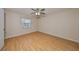 Bright bedroom featuring wood-look floors and a ceiling fan at 1936 Grand Cypress Ln, Sun City Center, FL 33573