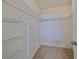 Walk-in closet with wire shelving for ample storage at 1936 Grand Cypress Ln, Sun City Center, FL 33573