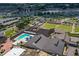 Aerial view of community with pool, clubhouse, and lawn bowling at 1936 Grand Cypress Ln, Sun City Center, FL 33573