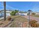 Landscaped yard with a brick driveway leading to a two-car garage at 1936 Grand Cypress Ln, Sun City Center, FL 33573