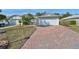 Two-story house with a brick driveway and attached garage at 1936 Grand Cypress Ln, Sun City Center, FL 33573