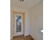 Beige front door with a glass panel and blinds at 1936 Grand Cypress Ln, Sun City Center, FL 33573