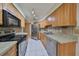 Kitchen with stainless steel appliances and wood cabinets at 1936 Grand Cypress Ln, Sun City Center, FL 33573