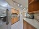 Modern kitchen featuring stainless steel appliances and ample cabinetry at 1936 Grand Cypress Ln, Sun City Center, FL 33573