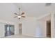 Living room with vaulted ceiling and sliding glass doors at 1936 Grand Cypress Ln, Sun City Center, FL 33573