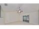 Living room with vaulted ceiling and sliding doors to patio at 1936 Grand Cypress Ln, Sun City Center, FL 33573