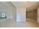Open living space with access to a sunroom and hallway at 1936 Grand Cypress Ln, Sun City Center, FL 33573
