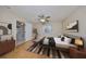 Main bedroom with wood floors, large window, and ceiling fan at 1936 Grand Cypress Ln, Sun City Center, FL 33573