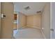 Empty spare room with access to kitchen at 1936 Grand Cypress Ln, Sun City Center, FL 33573