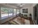 Relaxing sunroom with wood-look floors and backyard access at 1936 Grand Cypress Ln, Sun City Center, FL 33573