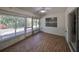 Spacious sunroom with wood-look floors and plenty of natural light at 1936 Grand Cypress Ln, Sun City Center, FL 33573