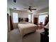 Bright bedroom with a king-size bed and ceiling fan at 20841 Eustis Rd, Land O Lakes, FL 34637