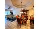 Open concept dining area with a glass-top table and wooden hutch at 20841 Eustis Rd, Land O Lakes, FL 34637