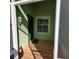 Inviting front porch with tiled flooring and exterior light at 20841 Eustis Rd, Land O Lakes, FL 34637