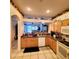 Kitchen with light wood cabinets, microwave, and a dishwasher at 20841 Eustis Rd, Land O Lakes, FL 34637
