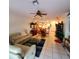 Open living room with sectional sofa and view into dining area at 20841 Eustis Rd, Land O Lakes, FL 34637