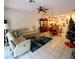 Living room with sectional sofa, Christmas tree and view of dining area at 20841 Eustis Rd, Land O Lakes, FL 34637