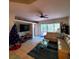 Spacious living room with a sectional sofa and access to a screened porch at 20841 Eustis Rd, Land O Lakes, FL 34637