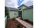 Brick pathway leading to the entrance of a light green house at 20841 Eustis Rd, Land O Lakes, FL 34637