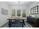 Bright dining room with a rustic wooden table and built-in bench seating at 2085 Alimara Ct, Odessa, FL 33556