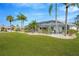 Landscaped backyard with lush lawn and screened pool at 2357 Emerald Lake Dr, Sun City Center, FL 33573