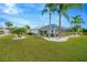 Landscaped backyard with screened-in patio at 2357 Emerald Lake Dr, Sun City Center, FL 33573