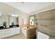 Bathroom boasts a soaking tub, walk-in shower, and stained glass window at 2357 Emerald Lake Dr, Sun City Center, FL 33573