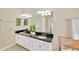 Double vanity bathroom with granite countertops and lots of cabinet space at 2357 Emerald Lake Dr, Sun City Center, FL 33573