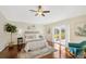 Main bedroom with wood floors, sliding doors to lanai, and ceiling fan at 2357 Emerald Lake Dr, Sun City Center, FL 33573