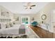 Main bedroom with wood floors, sliding doors to pool, and ceiling fan at 2357 Emerald Lake Dr, Sun City Center, FL 33573