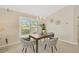 Elegant dining room with wood table and woven chairs at 2357 Emerald Lake Dr, Sun City Center, FL 33573