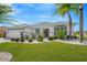 Single-story home with landscaped yard, two-car garage, and attractive curb appeal at 2357 Emerald Lake Dr, Sun City Center, FL 33573