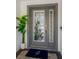 Gray front door with stained glass accents and a welcoming entry mat at 2357 Emerald Lake Dr, Sun City Center, FL 33573