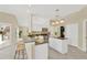 Open kitchen with white cabinets, granite counters and island at 2357 Emerald Lake Dr, Sun City Center, FL 33573