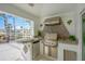 Outdoor kitchen with stainless steel appliances and built-in sink at 2357 Emerald Lake Dr, Sun City Center, FL 33573