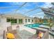 Spacious patio with comfortable seating and a screened pool at 2357 Emerald Lake Dr, Sun City Center, FL 33573
