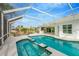 Relaxing screened pool and spa with outdoor kitchen at 2357 Emerald Lake Dr, Sun City Center, FL 33573